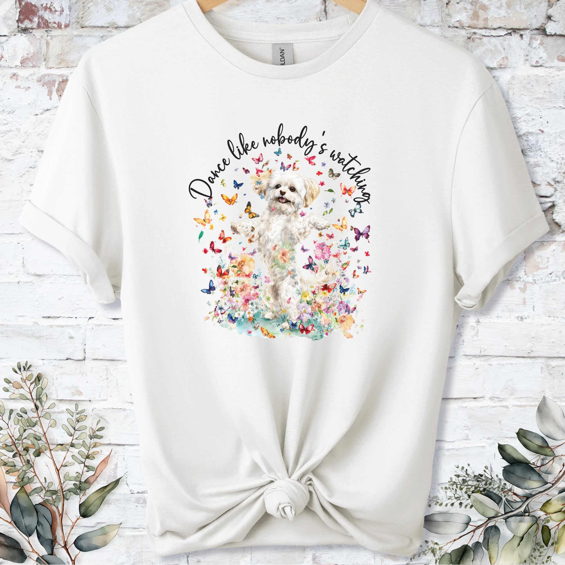 https://wescale-cdn.com/generated-mockups/bf472b68-5c1c-44c3-a409-4b955cabfa92/69acafd1-585e-4806-952c-4f06a54c82f8/3e8a5956-7015-46e5-b1dc-8a0d0bd2176b_designs/cavichon_1_dance_like_nobody_s_watching_unisex_t_shirt_2_1777546009084_tktpvs.png_1777546010168.webp