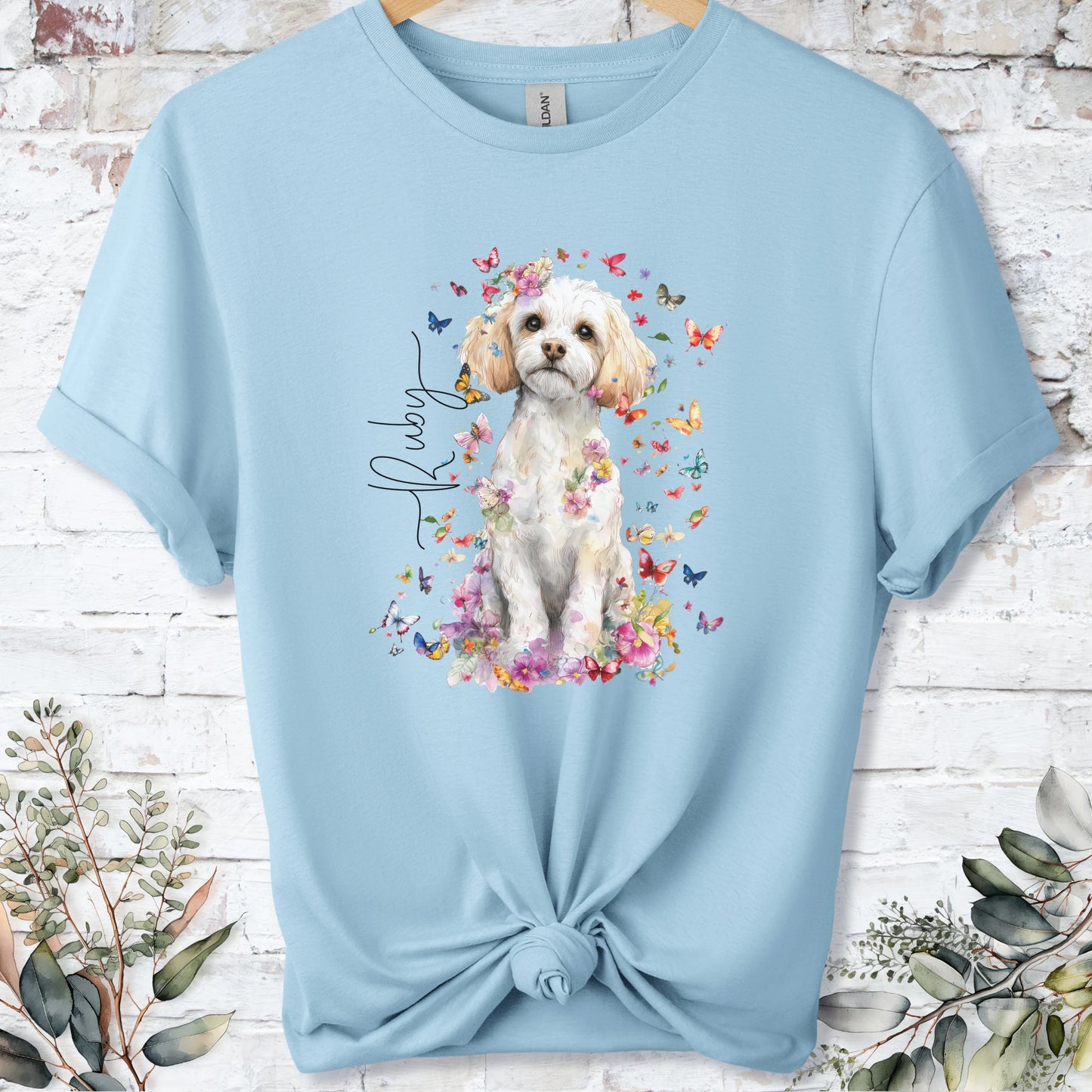 https://wescale-cdn.com/generated-mockups/bf472b68-5c1c-44c3-a409-4b955cabfa92/69acafd1-585e-4806-952c-4f06a54c82f8/954a667b-f3c9-43d0-badc-0388c4840f13_designs/cavichon_flora_personalised_unisex_t_shirt_2_1777545755472_kd08h5.png_1777545756612.webp