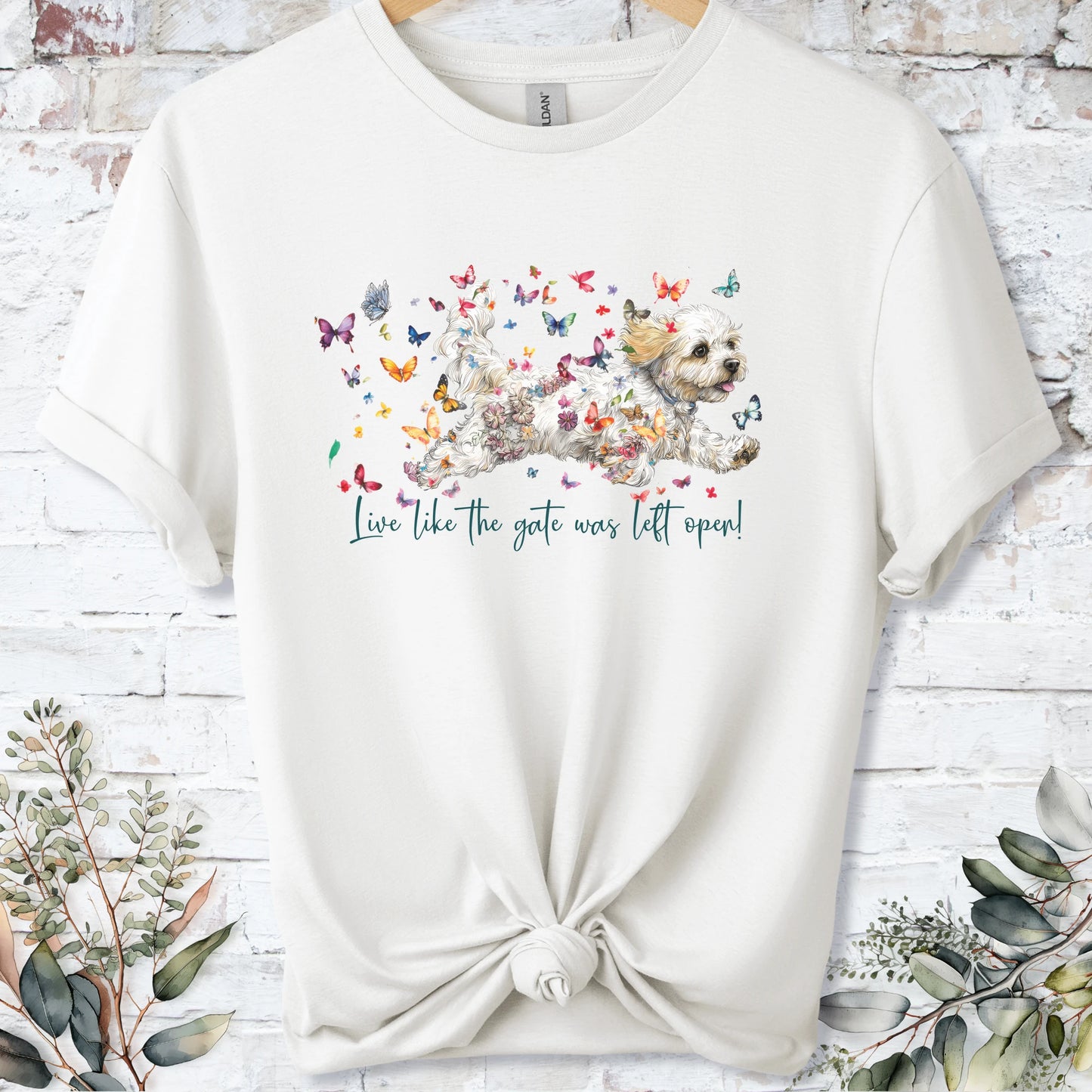 https://wescale-cdn.com/generated-mockups/bf472b68-5c1c-44c3-a409-4b955cabfa92/69acafd1-585e-4806-952c-4f06a54c82f8/3e8a5956-7015-46e5-b1dc-8a0d0bd2176b_designs/cavichon_live_like_the_gate_was_left_open_unisex_t_shirt_2_1777545930387_5e25n7.png_1777545931620.webp