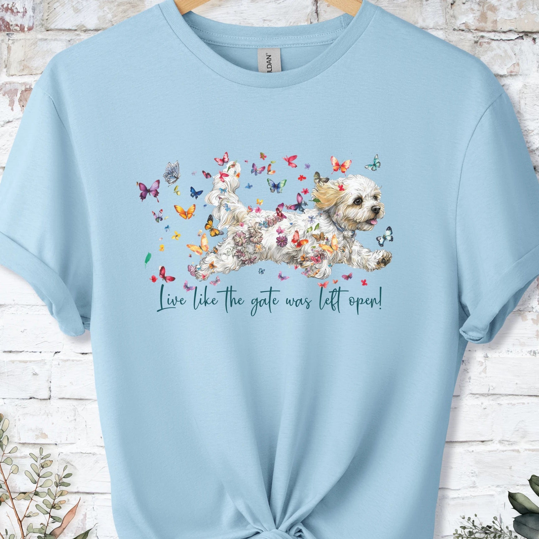 https://wescale-cdn.com/generated-mockups/bf472b68-5c1c-44c3-a409-4b955cabfa92/69acafd1-585e-4806-952c-4f06a54c82f8/954a667b-f3c9-43d0-badc-0388c4840f13_designs/cavichon_live_like_the_gate_was_left_open_unisex_t_shirt_2_1777545930387_5e25n7.png_1777545931620.webp