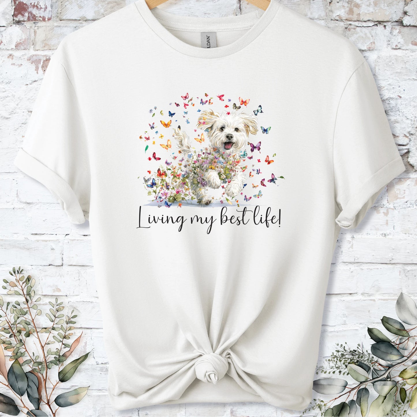 https://wescale-cdn.com/generated-mockups/bf472b68-5c1c-44c3-a409-4b955cabfa92/69acafd1-585e-4806-952c-4f06a54c82f8/3e8a5956-7015-46e5-b1dc-8a0d0bd2176b_designs/cavichon_living_my_best_life_2_unisex_t_shirt_2_1777545970919_en9ugv.png_1777545972173.webp
