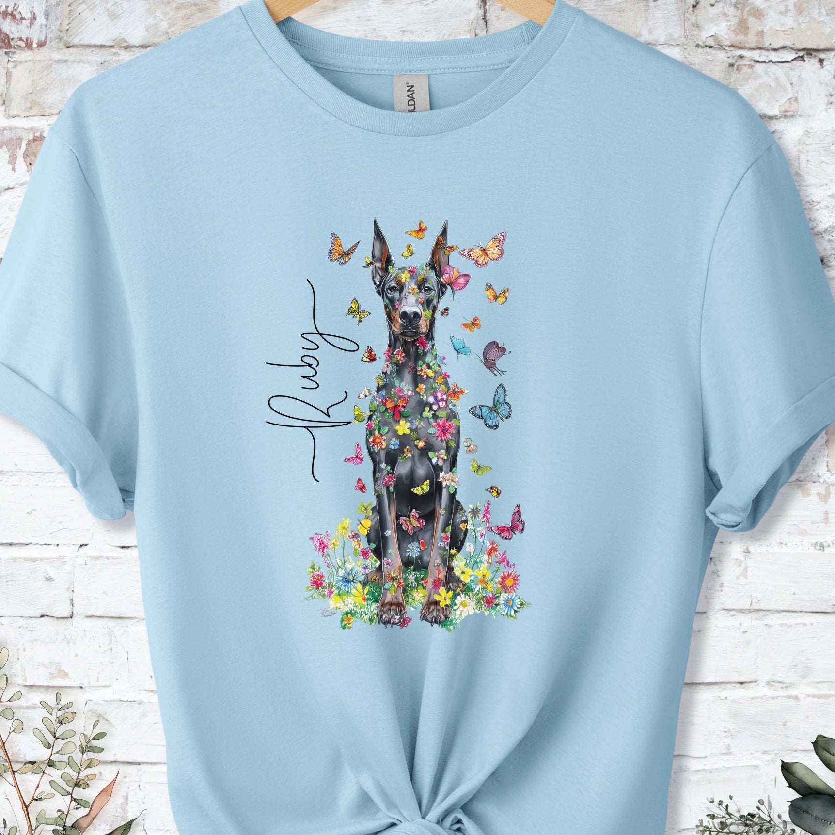 https://wescale-cdn.com/generated-mockups/bf472b68-5c1c-44c3-a409-4b955cabfa92/533a35f1-5739-476c-9eba-37ec84cbbba2/954a667b-f3c9-43d0-badc-0388c4840f13_designs/doberman_pinscher_8_floral_butterfly_personalised_t_shirt_2_1777074792388_1qicuf.png_1777074795305.webp