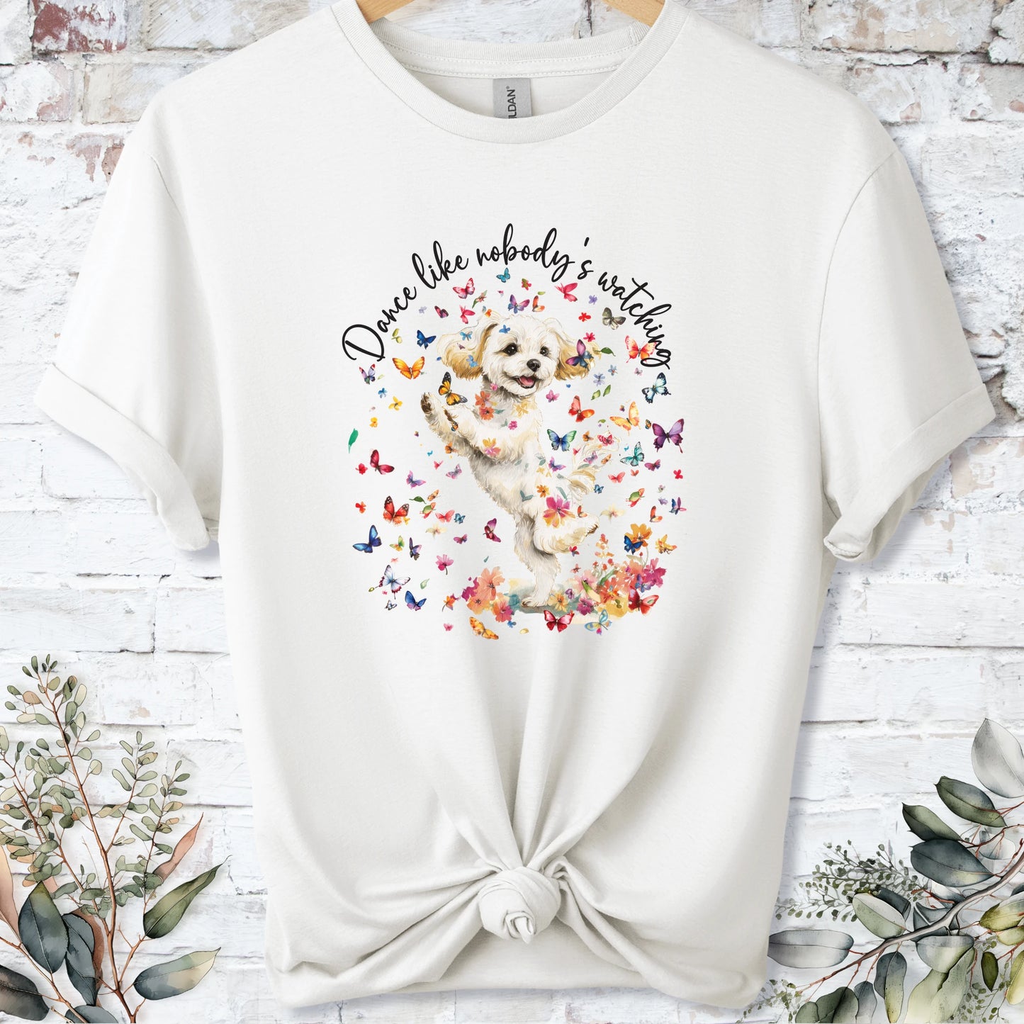 https://wescale-cdn.com/generated-mockups/bf472b68-5c1c-44c3-a409-4b955cabfa92/69acafd1-585e-4806-952c-4f06a54c82f8/3e8a5956-7015-46e5-b1dc-8a0d0bd2176b_designs/maltese_2_dance_like_nobody_s_watching_unisex_t_shirt_2_1777545846776_ywuo0g.png_1777545848162.webp