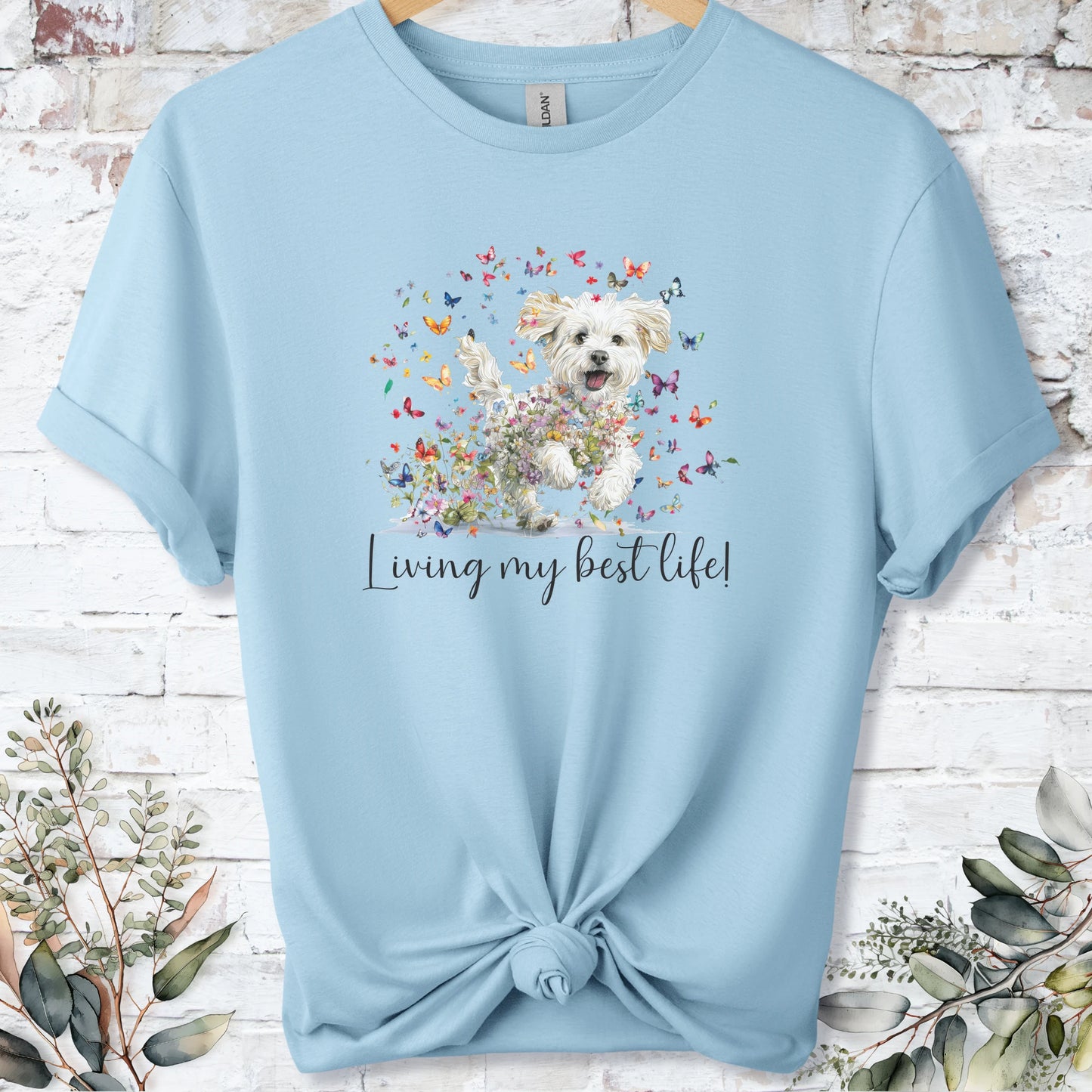 https://wescale-cdn.com/generated-mockups/bf472b68-5c1c-44c3-a409-4b955cabfa92/69acafd1-585e-4806-952c-4f06a54c82f8/954a667b-f3c9-43d0-badc-0388c4840f13_designs/maltese_living_my_best_life_2_unisex_t_shirt_2_1777545790833_1vlrjs.png_1777545793187.webp