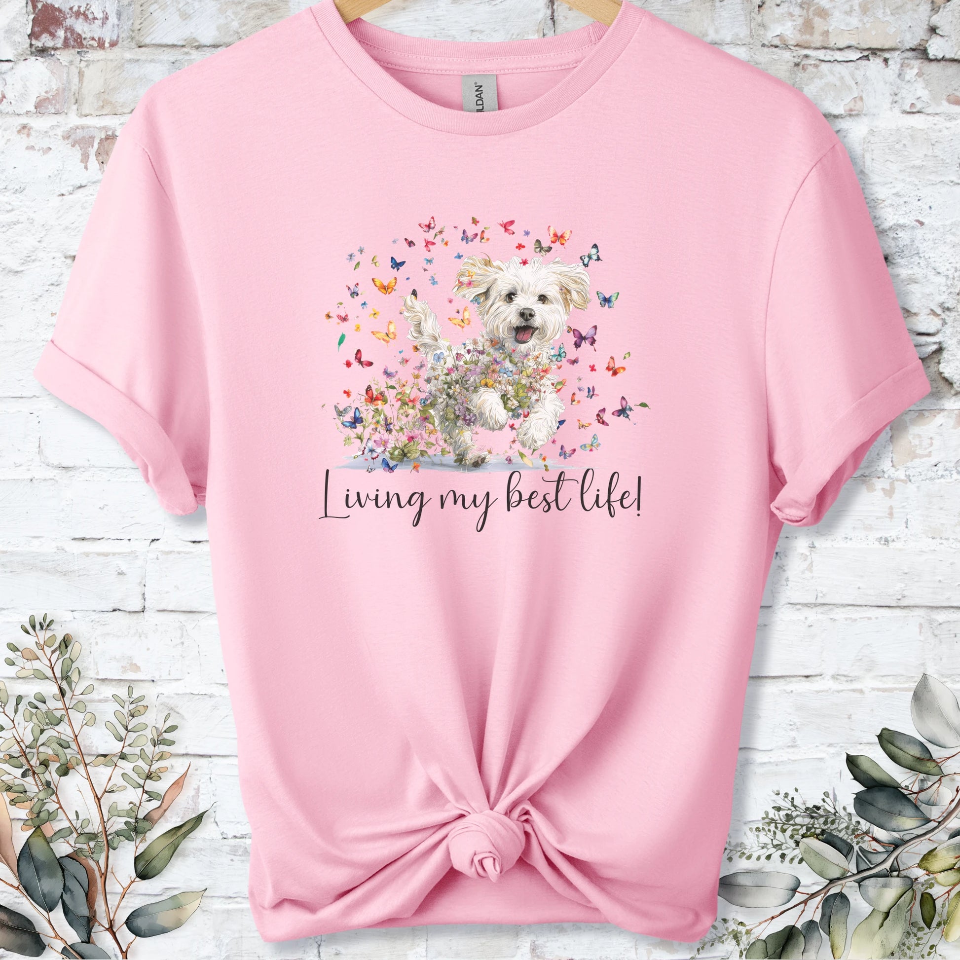 https://wescale-cdn.com/generated-mockups/bf472b68-5c1c-44c3-a409-4b955cabfa92/69acafd1-585e-4806-952c-4f06a54c82f8/37dc3834-33f9-47c9-b73e-9085ff95e0d1_designs/maltese_living_my_best_life_2_unisex_t_shirt_2_1777545790833_1vlrjs.png_1777545793187.webp